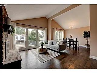 Living room with vaulted ceiling, fireplace and large windows